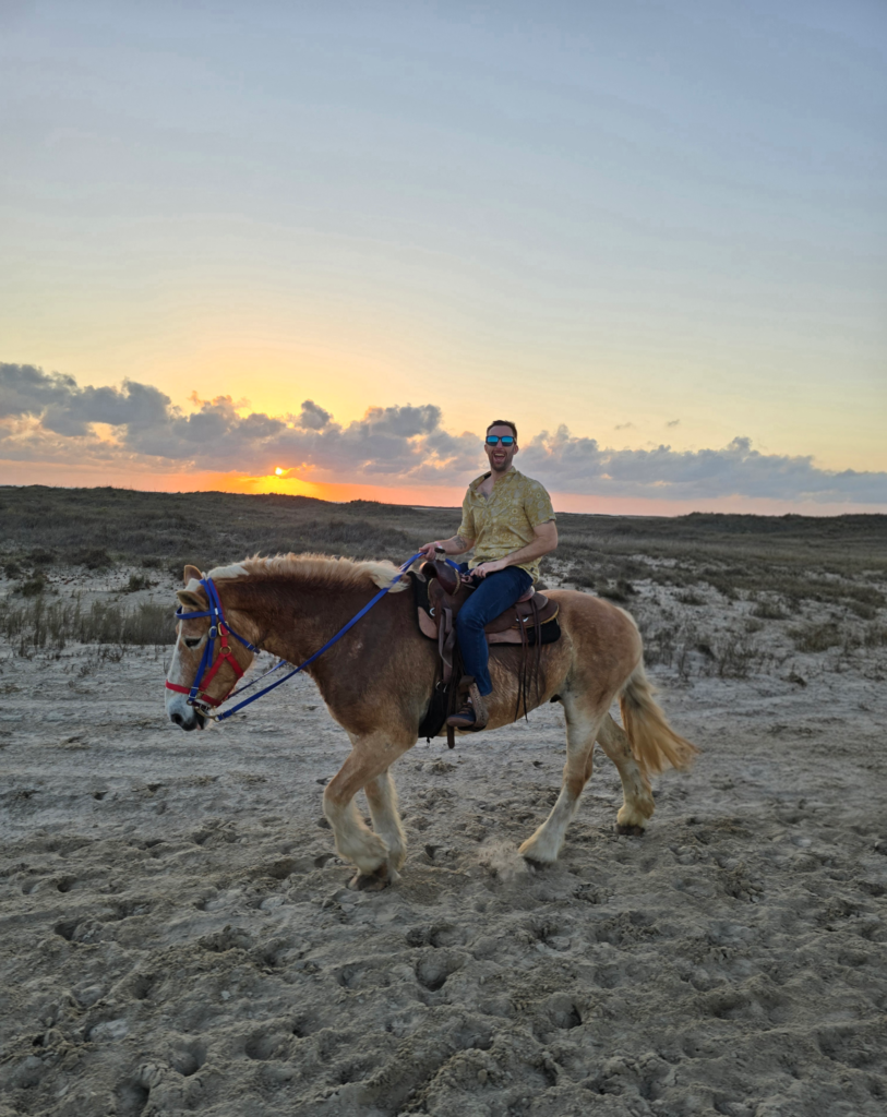 Rider silhouetted against the golden sunset sky on South Padre Island