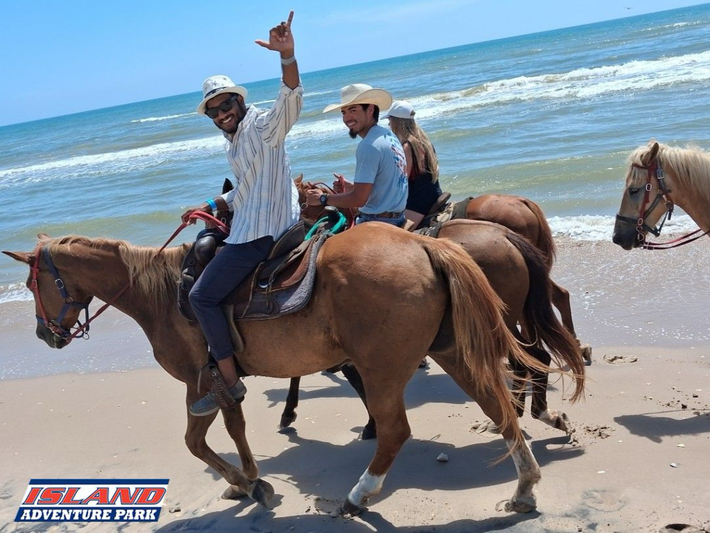 People horseback riding along the surf on the beach at South Padre Island