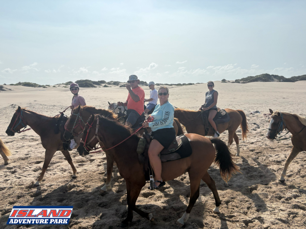Group horseback riding across the dunes at Island Adventure Park on South Padre Island